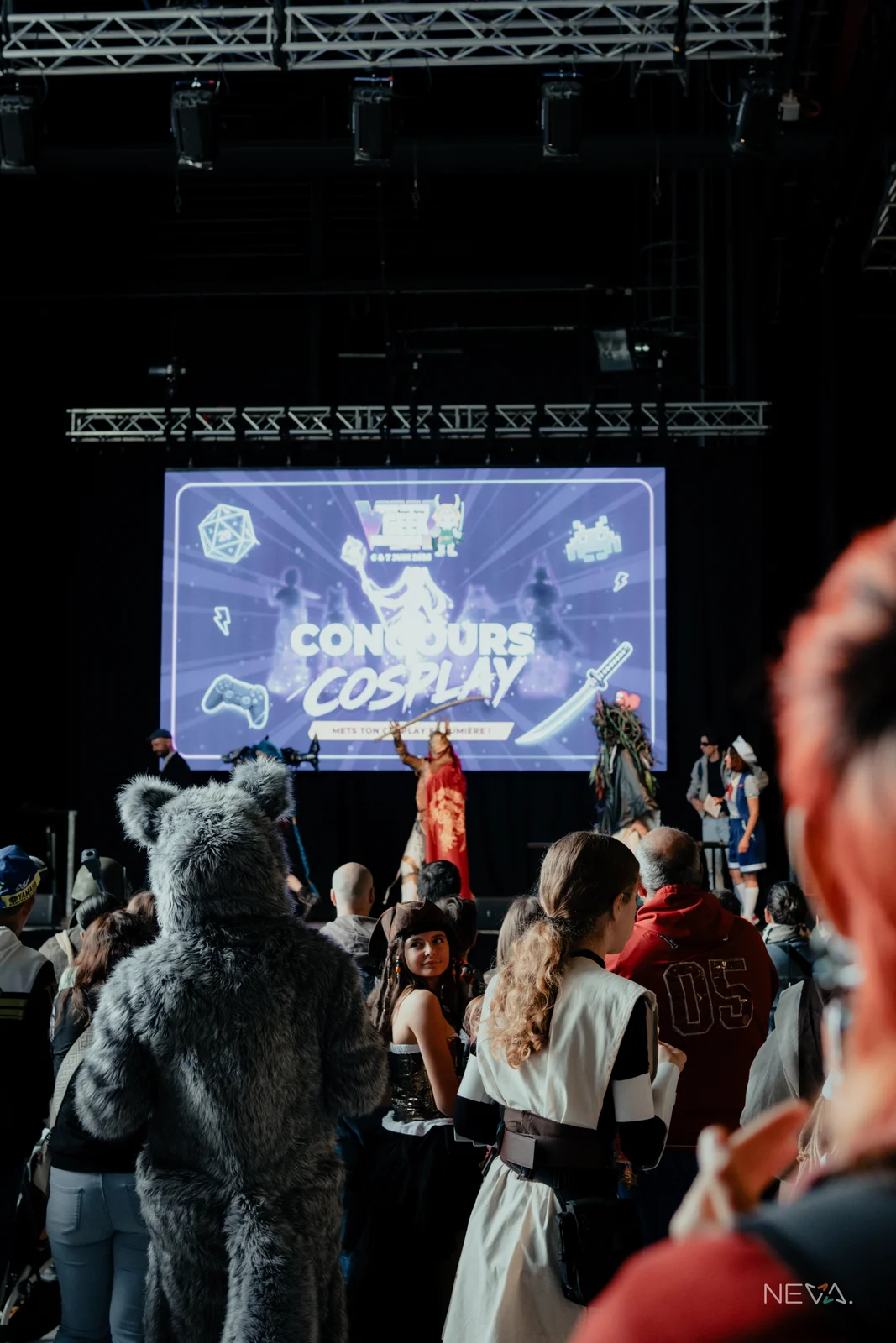 Le concours cosplay de la Margny-Compiègne Geek Convention, sur scène devant le public, avec l'écran Concours Cosplay en fond